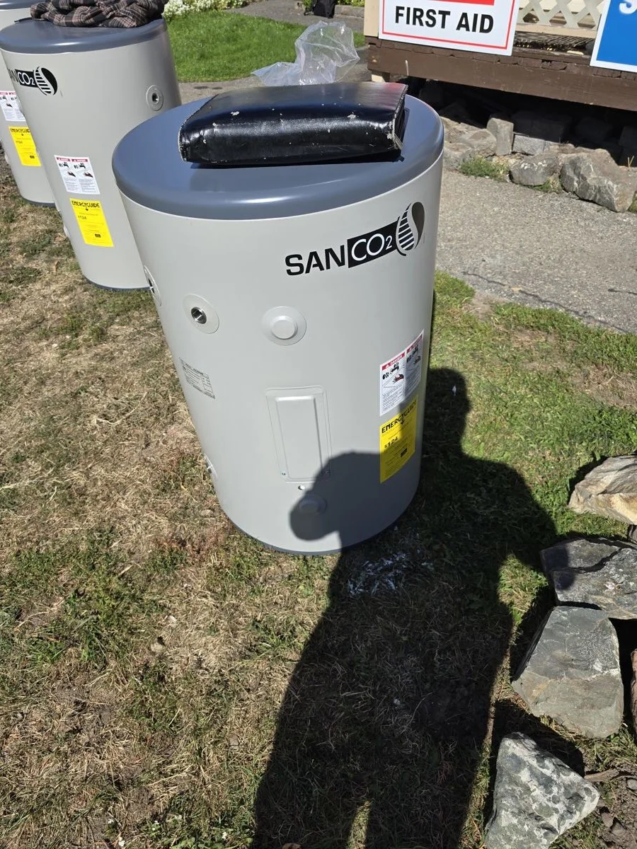 Heat pump water heater tank staged on site ahead of installation