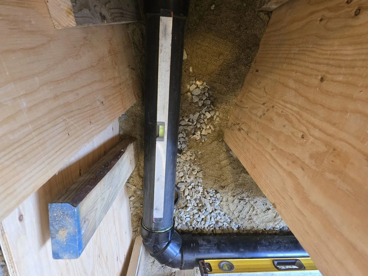 Drain line checked for fall with a level during installation