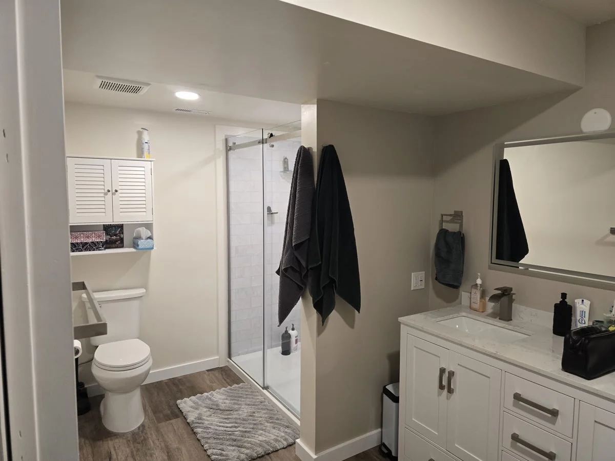 Completed bathroom renovation with walk-in shower and toilet