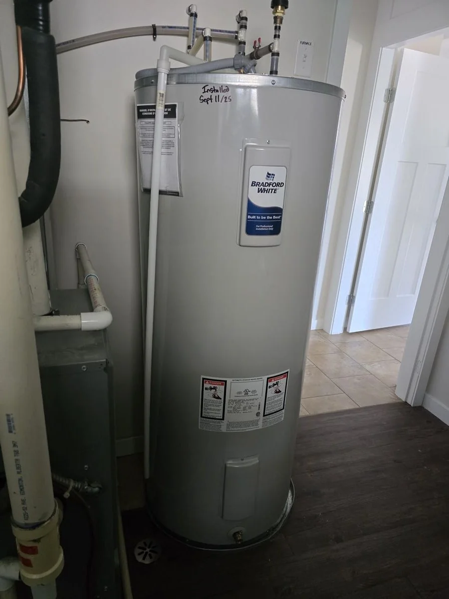 Electric hot water tank installed with copper connections and a thermal expansion tank