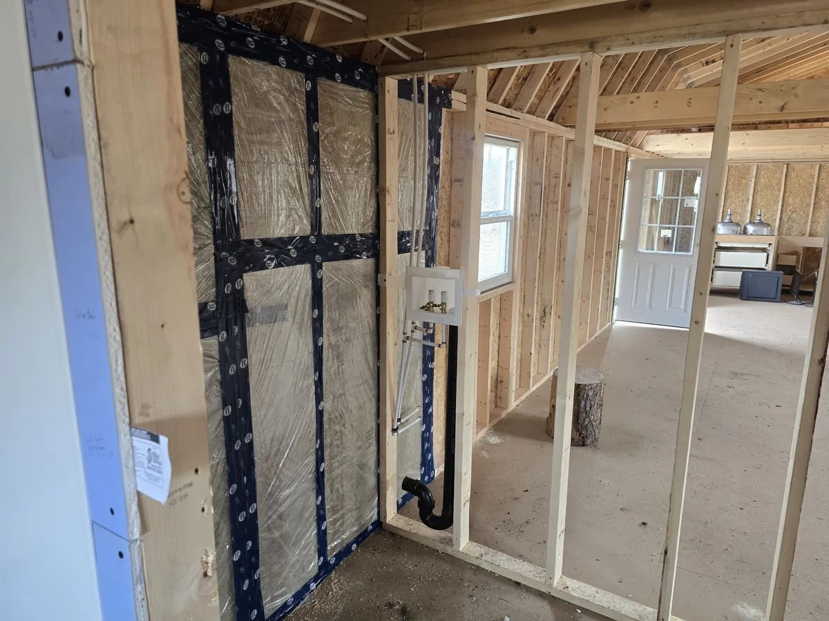 Water supply rough-in run through a framed wall before insulation