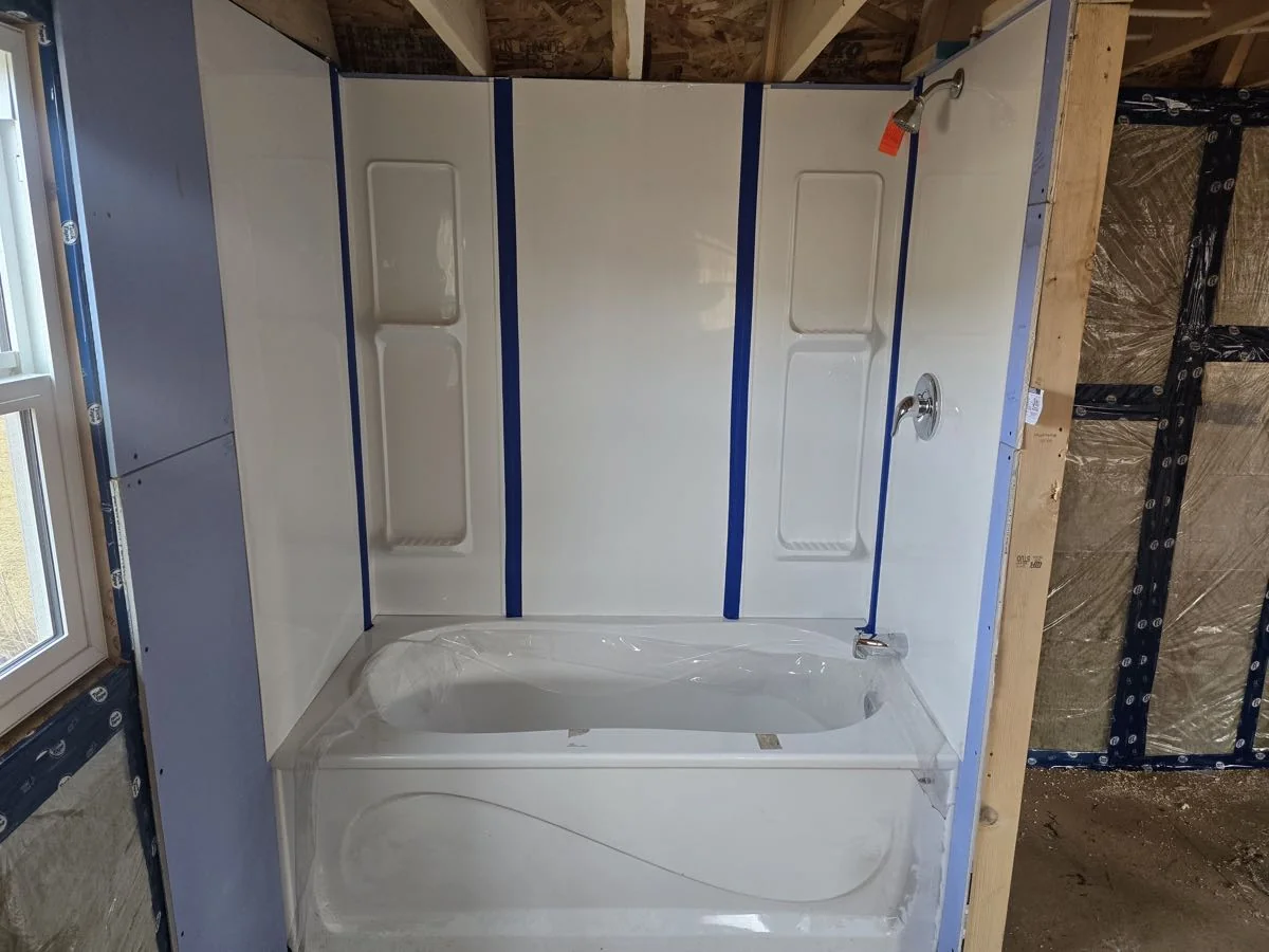 Bathtub set into a framed and vapour sealed bathroom