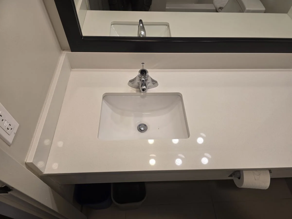 New vanity, sink and mirror installed in a renovated bathroom