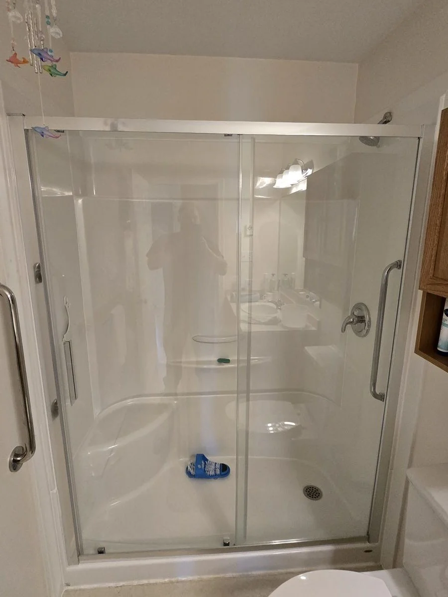 Glass shower enclosure installed in a finished bathroom