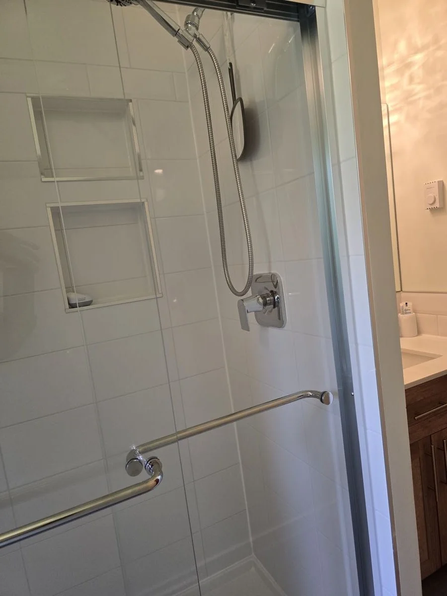 Completed shower with handheld fixture and built-in niches